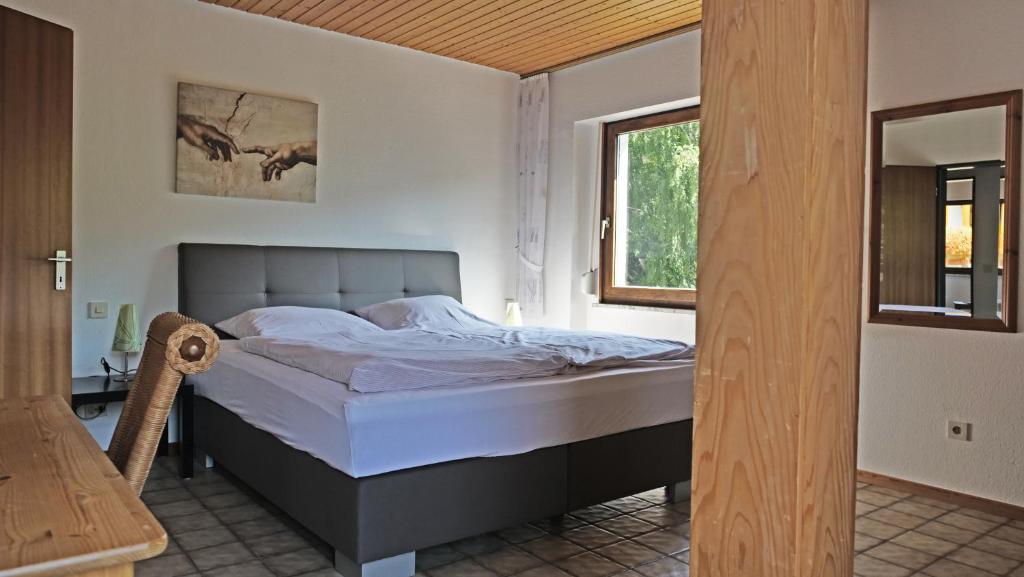 a bedroom with a bed in a room with a window at Gut Kallerbend in Nideggen