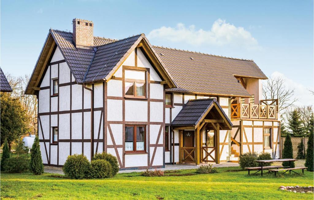 a house with a black and white building at Gorgeous Home In Postomino With Wifi in Postomino