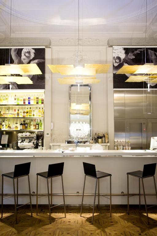 a bar in a restaurant with four stools at Hotel C2 in Marseille