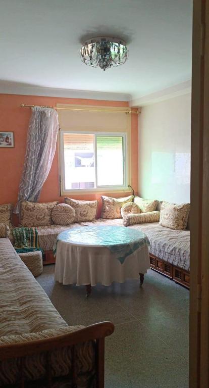 a living room with a couch and a table at Agdal Rabat in Rabat