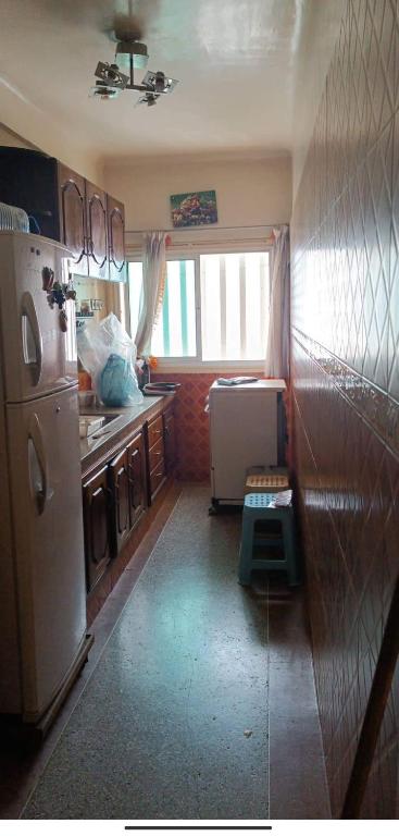 a kitchen with a white refrigerator and a sink at Agdal Rabat in Rabat