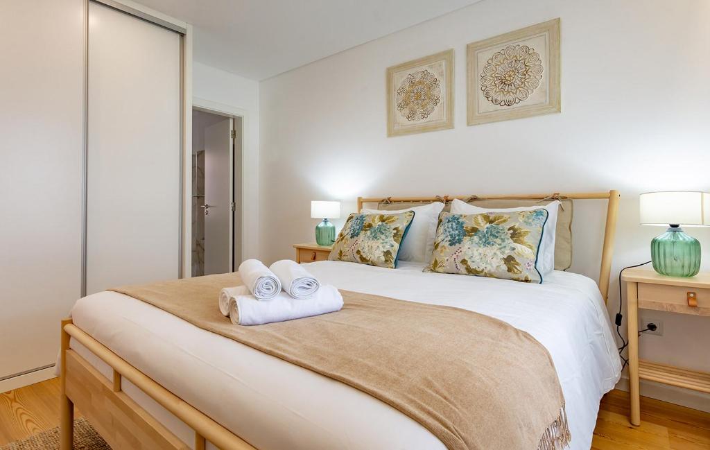 ein Schlafzimmer mit einem Bett mit zwei Handtüchern darauf in der Unterkunft Casa de Sao Tiago 2 in Funchal