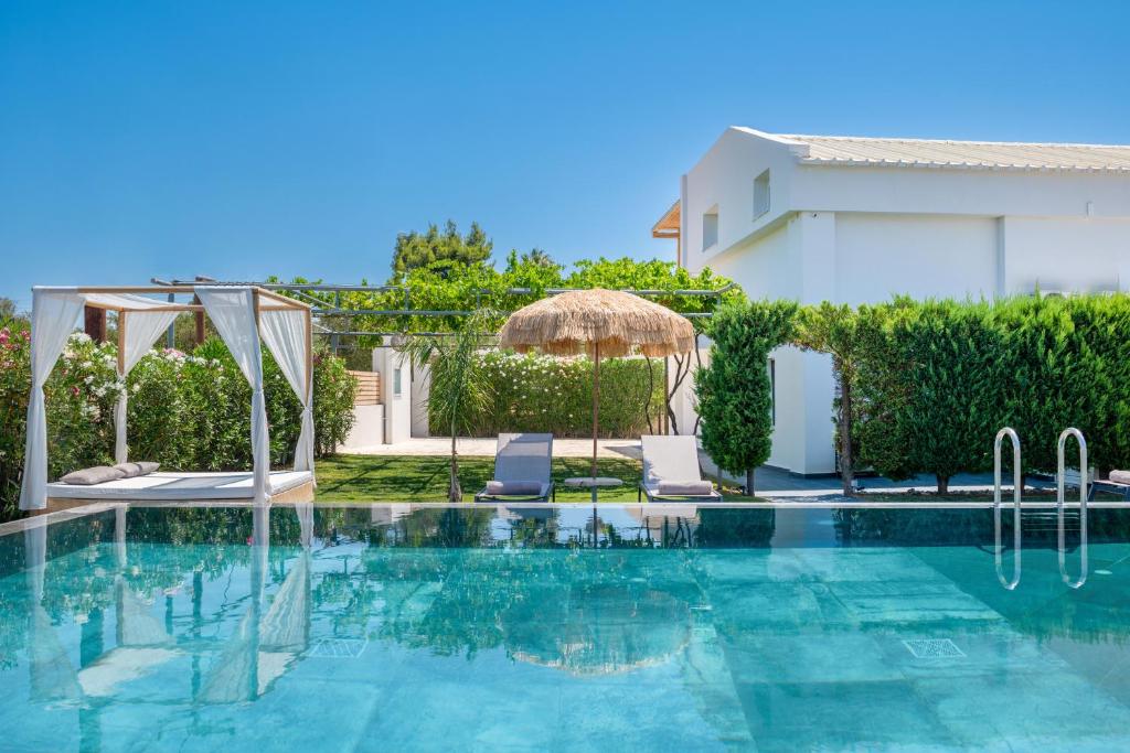 a swimming pool in front of a villa at Sonel Luxury Villa, a Family Retreat, By ThinkVilla in Mouzákion