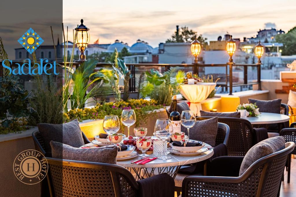a table on a balcony with glasses of wine at Sadaret Hotel-Old City Sultanahmet in Istanbul
