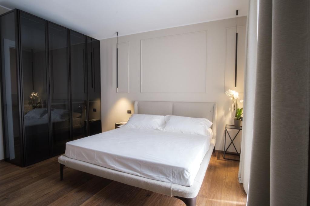 a bedroom with a white bed and a large window at PALAZZO DANISI ROOMS&SUITES in Bari