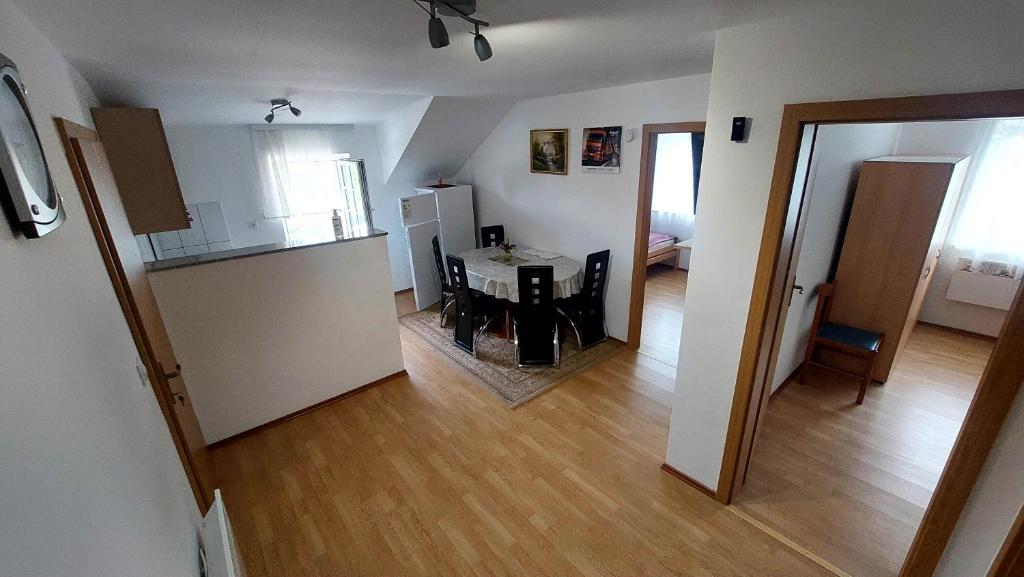 a kitchen and a living room with a table at Apartma ASJA in Brežice