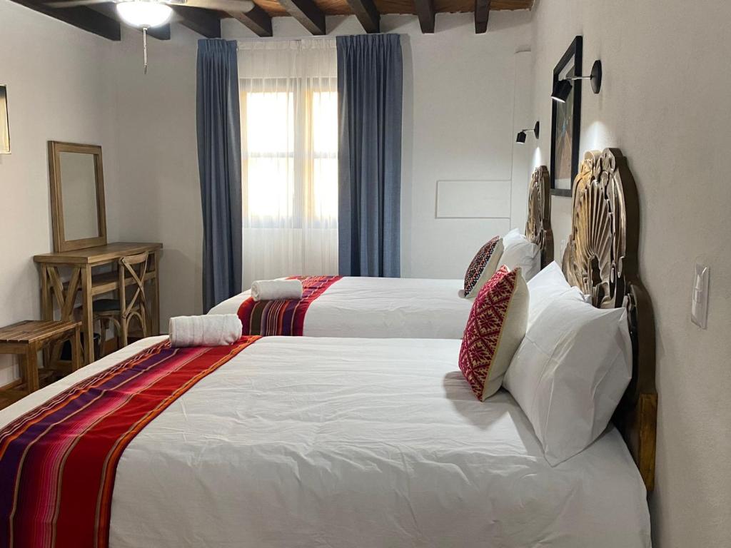 Postel nebo postele na pokoji v ubytování Hotel La Lejona