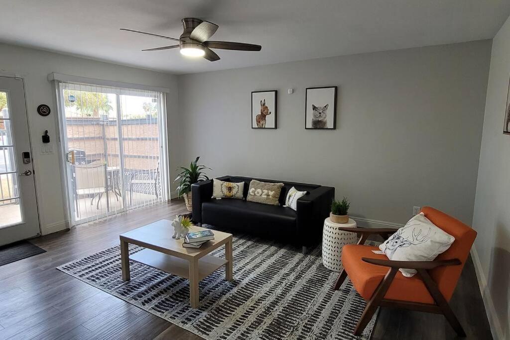 a living room with a black couch and a table at L - Fully remodeled and professionally decorated in Las Vegas