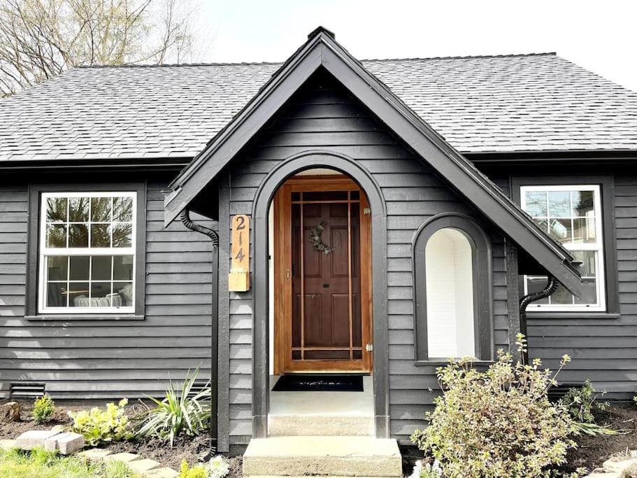a black house with a brown door and windows at Modern 2 Bedroom Farmhouse Cottage with Hot Tub in Snohomish in Snohomish