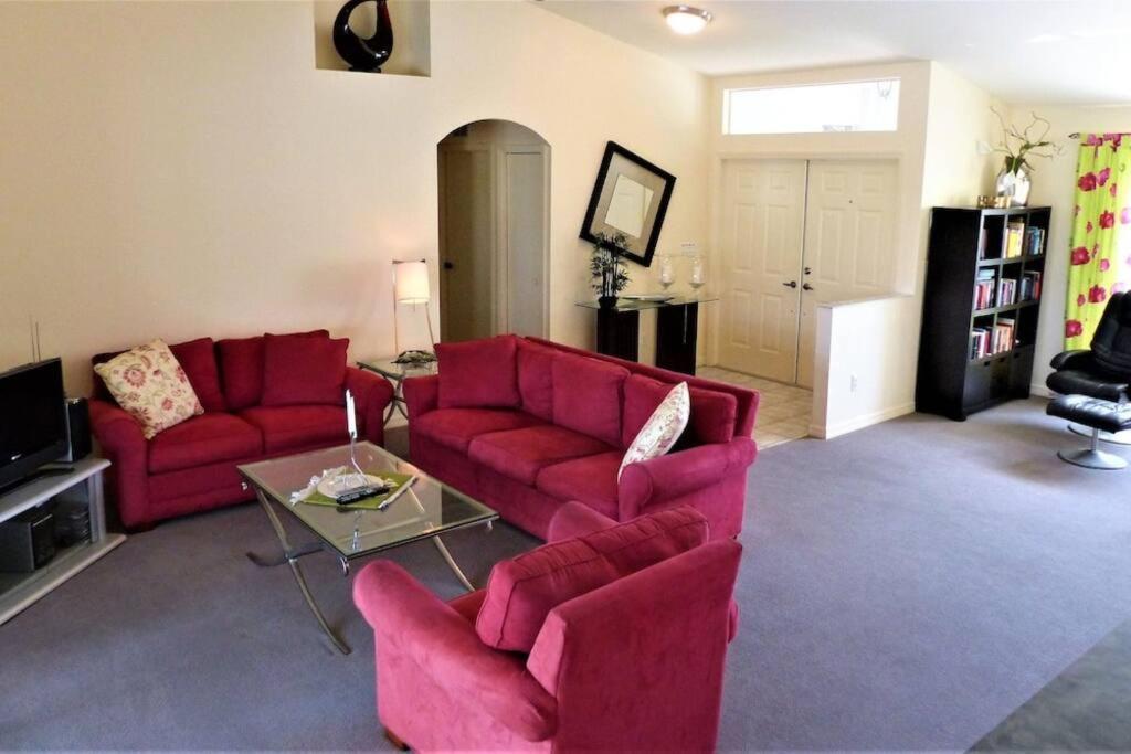 a living room with two red couches and a table at Maria Maria * vacation rental with amazing lake vi in Lehigh Acres