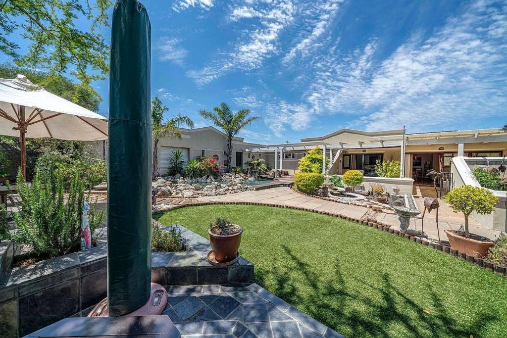 a person is standing on a patio with a yard at Kaya La Provence in Cape Town