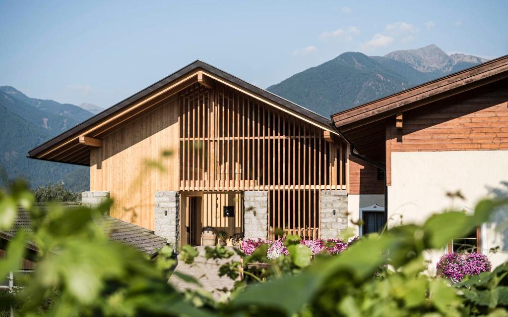 a wooden building with mountains in the background at Stadl Chalet oberhalb Brixen in Rosa