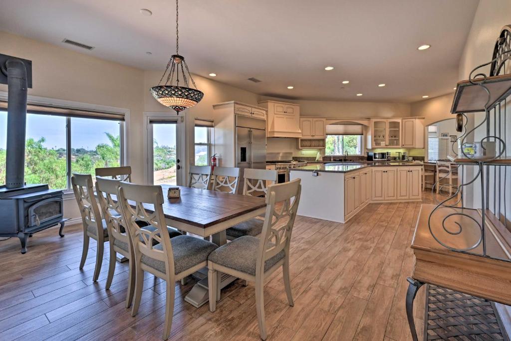 a kitchen and dining room with a table and chairs at Luxe Vista Getaway with Private Pool and Hot Tub! in Vista