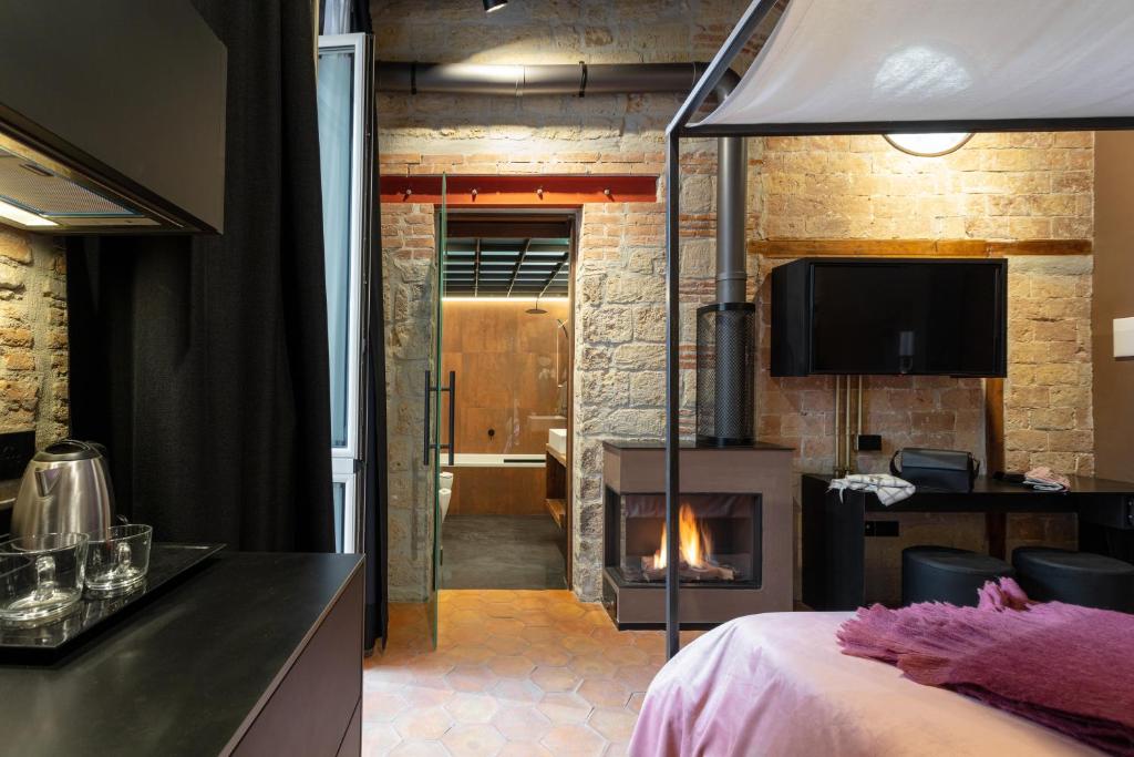 een kamer met een bed, een open haard en een televisie bij Palazzo Residenza Madre in Napels