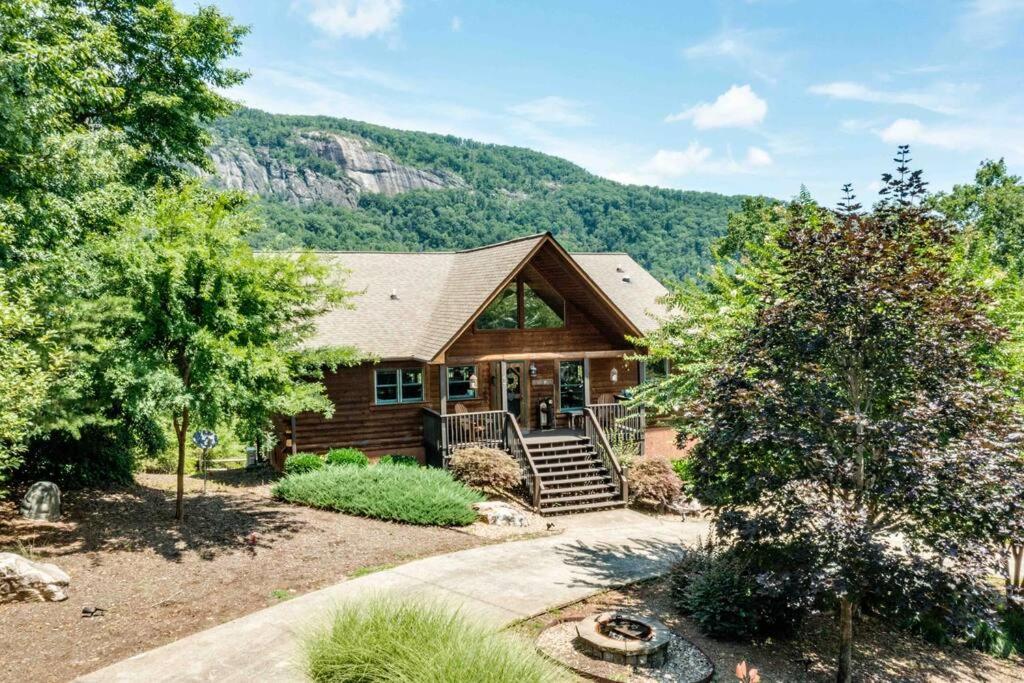 a log home with a mountain in the background at Wild Valley Lodge-Log Cabin in Lake Lure, NC, Close to Chimney Rock - Stunning Views in Lake Lure