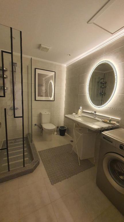 a bathroom with a sink and a toilet and a shower at Soma Bay Ambiance - Relaxed Apartment - Next to The Breakers in Hurghada