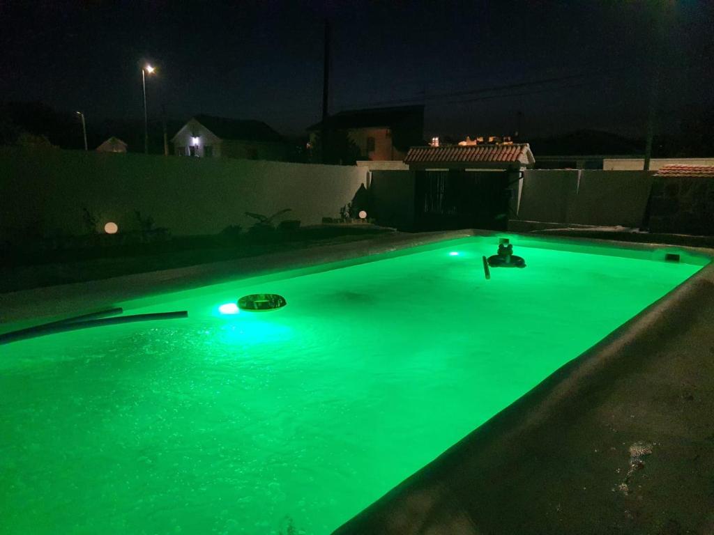 a swimming pool with green illumination at night at El lazarillo de tormes in Escalona