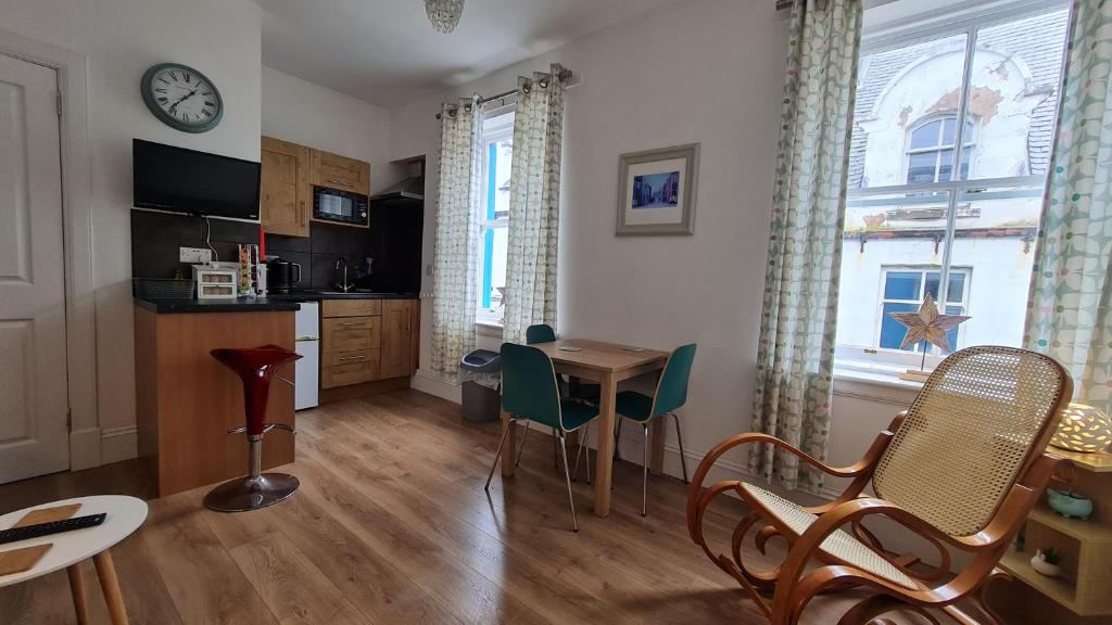 a kitchen and dining room with a table and chairs at Hebridean Town House in Stornoway
