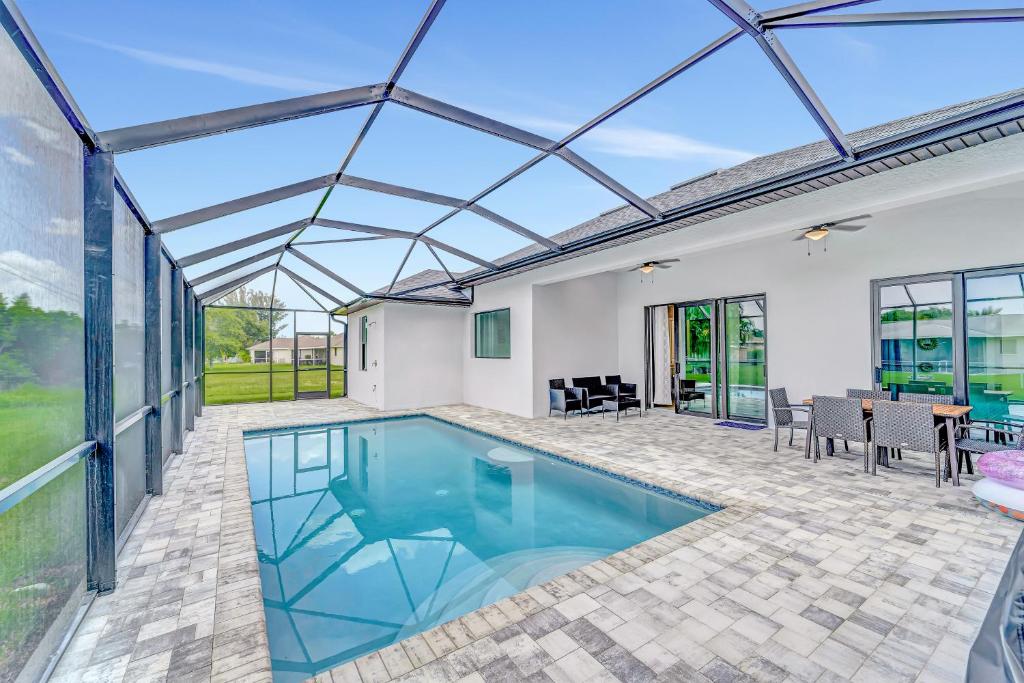 an indoor swimming pool with a glass roof at Seashell of the Ball in Cape Coral