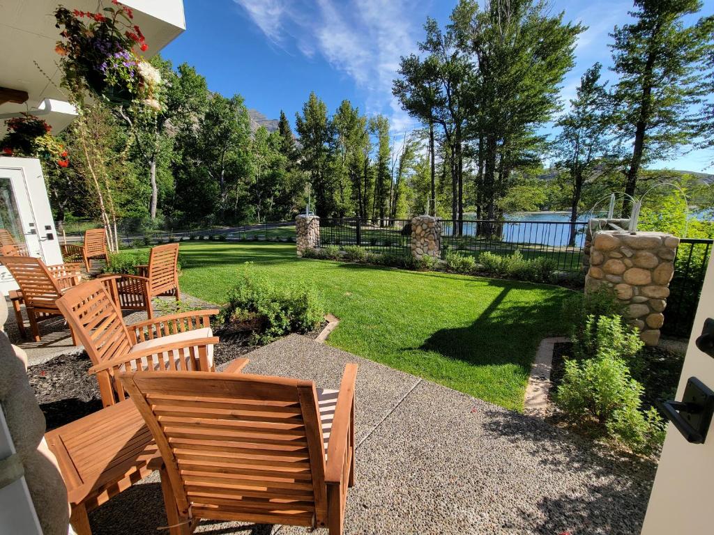 a patio with a bunch of chairs and a yard at Kilmorey Lodge in Waterton Park