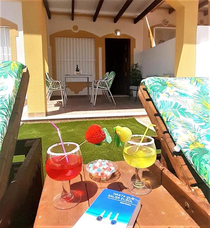 two cocktails on a table in front of a house at Bungalow Flor de Lirio in Mazarrón