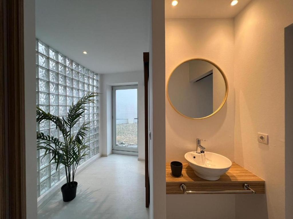 a bathroom with a sink and a mirror on the wall at BALCÓN DO MARIÑEIRO in Burela de Cabo