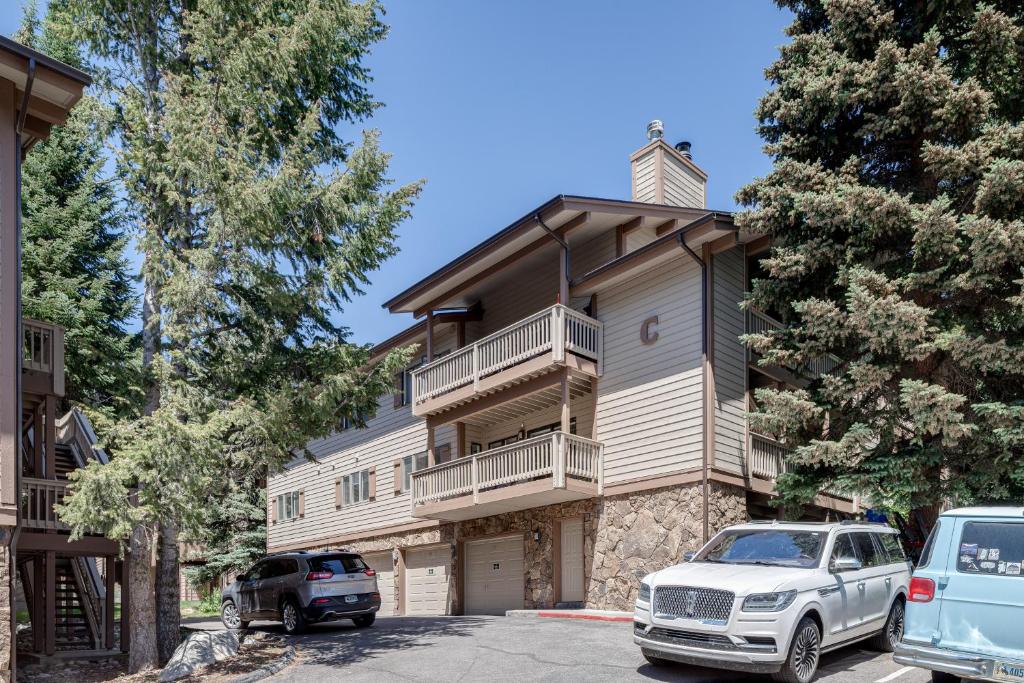 a building with cars parked in front of it at Teewinot C2 in Teton Village