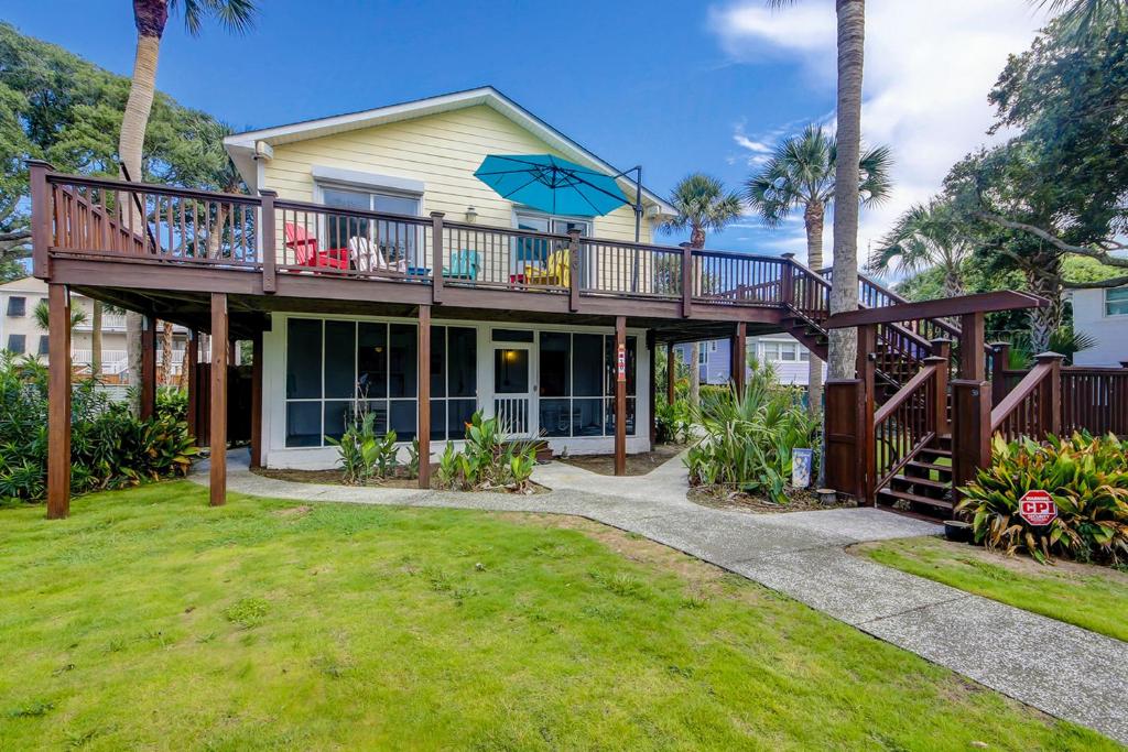 a house with a deck and a balcony at SeaEscape in Folly Beach