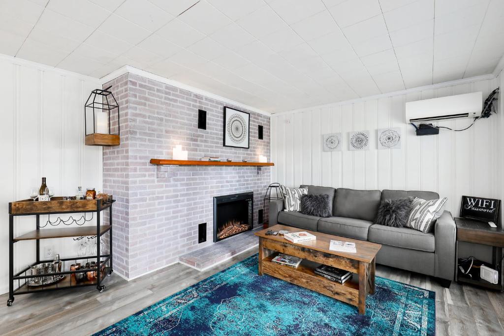 a living room with a couch and a fireplace at River House on Berwick Trail in Nashville