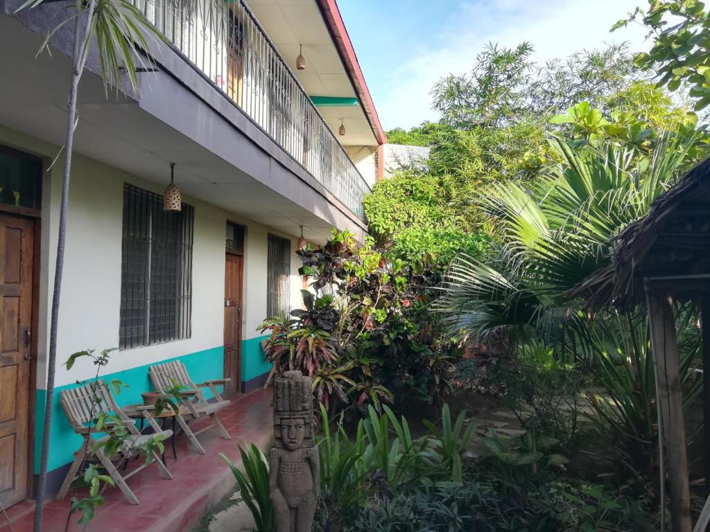 a guest house with a balcony and plants at Harvest House in León