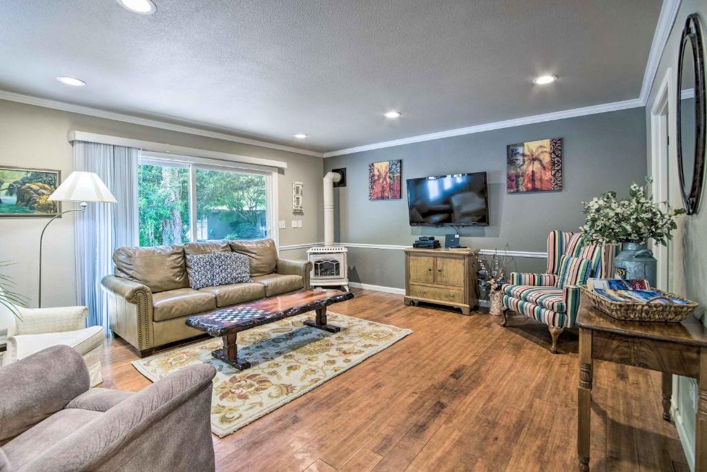 a living room with a couch and a tv at Coos Bay Retreat Less Than 2 Mi to Marina and Casino! in Coos Bay