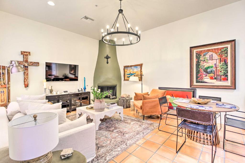 una sala de estar con muebles blancos y una cruz en la pared en Sunny Adobe Retreat with Hot Tub and Mtn Views!, en Tubac