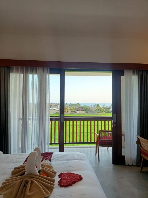 a hotel room with a view of a balcony at The Kd Suites & Coffee Shop in Munggu