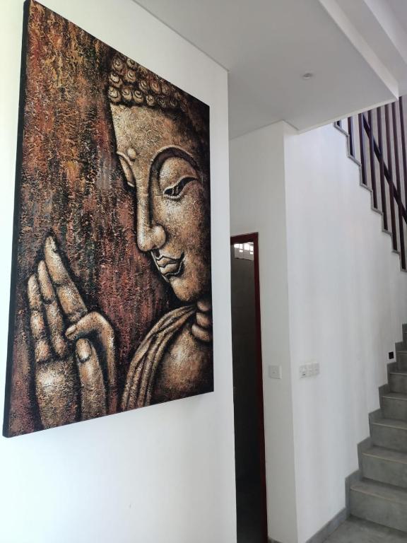 a large painting on a wall in a stair case at The Kd Suites & Coffee Shop in Munggu