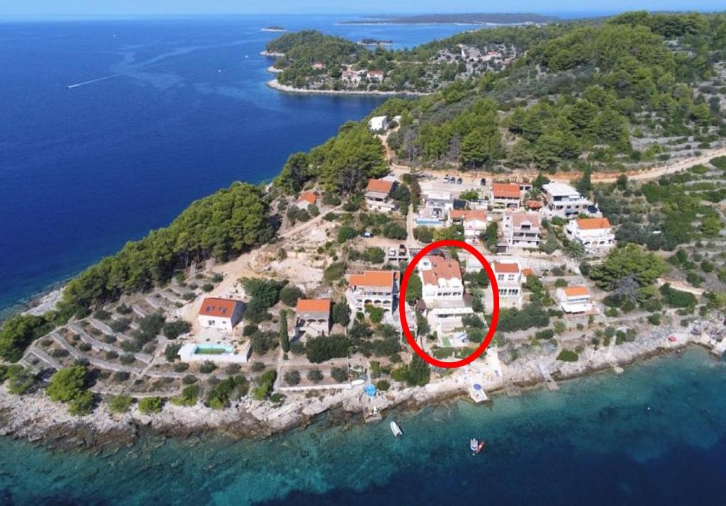 a house on an island in the water at Apartments by the sea Cove Mikulina Luka, Korcula - 9181 in Vela Luka