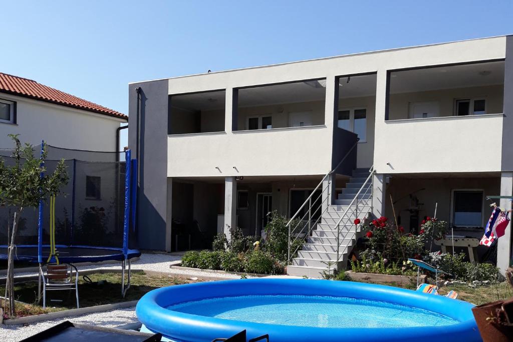 an apartment building with a pool in front of it at Apartments with a parking space Stinjan, Pula - 14106 in Pula
