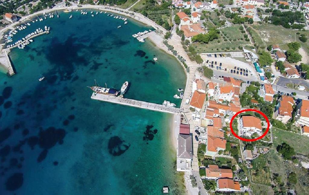 an aerial view of a harbor with a red circle at Apartments by the sea Martinscica, Cres - 14334 in Martinšćica