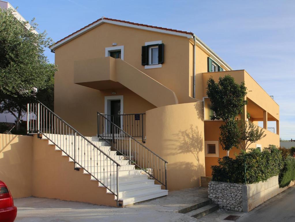 a house with stairs in front of it at Apartments by the sea Razanj, Rogoznica - 14357 in Rogoznica