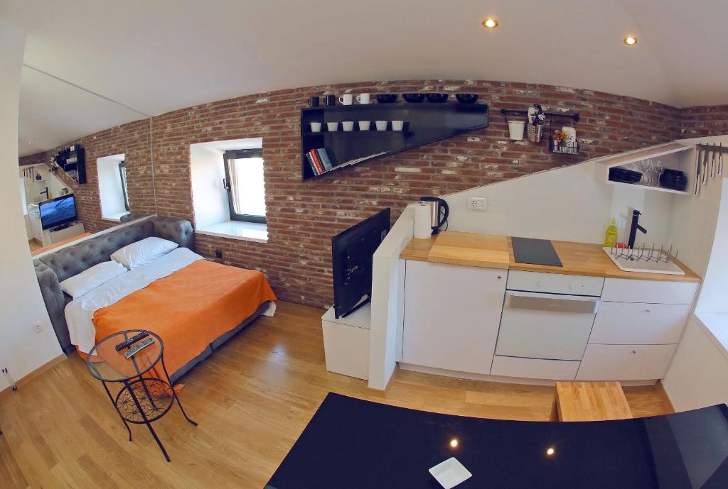 a small room with a bed and a kitchen in it at Apartments with WiFi Zadar - 14529 in Zadar