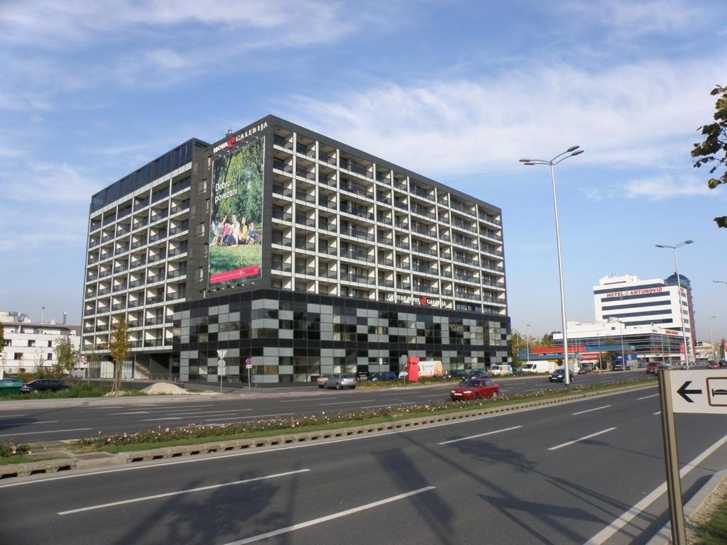 a large building with a billboard on the side of a road at Apartments with WiFi Zagreb - 16462 in Zagreb