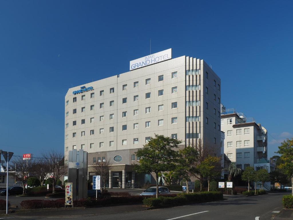 a white building with a sign on top of it at Imari Grand Hotel in Imari