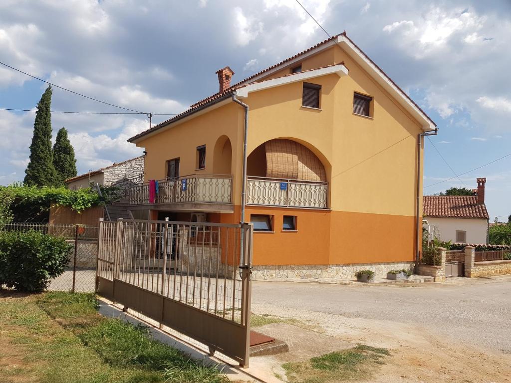 a house with a fence in front of it at Apartments with a parking space Tar, Porec - 16475 in Tar