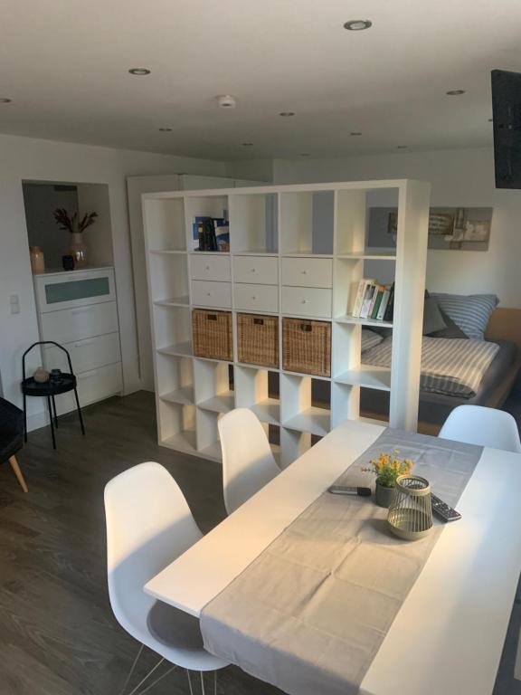 a living room with a white table and chairs at City Apartments am Rhein in Bonn