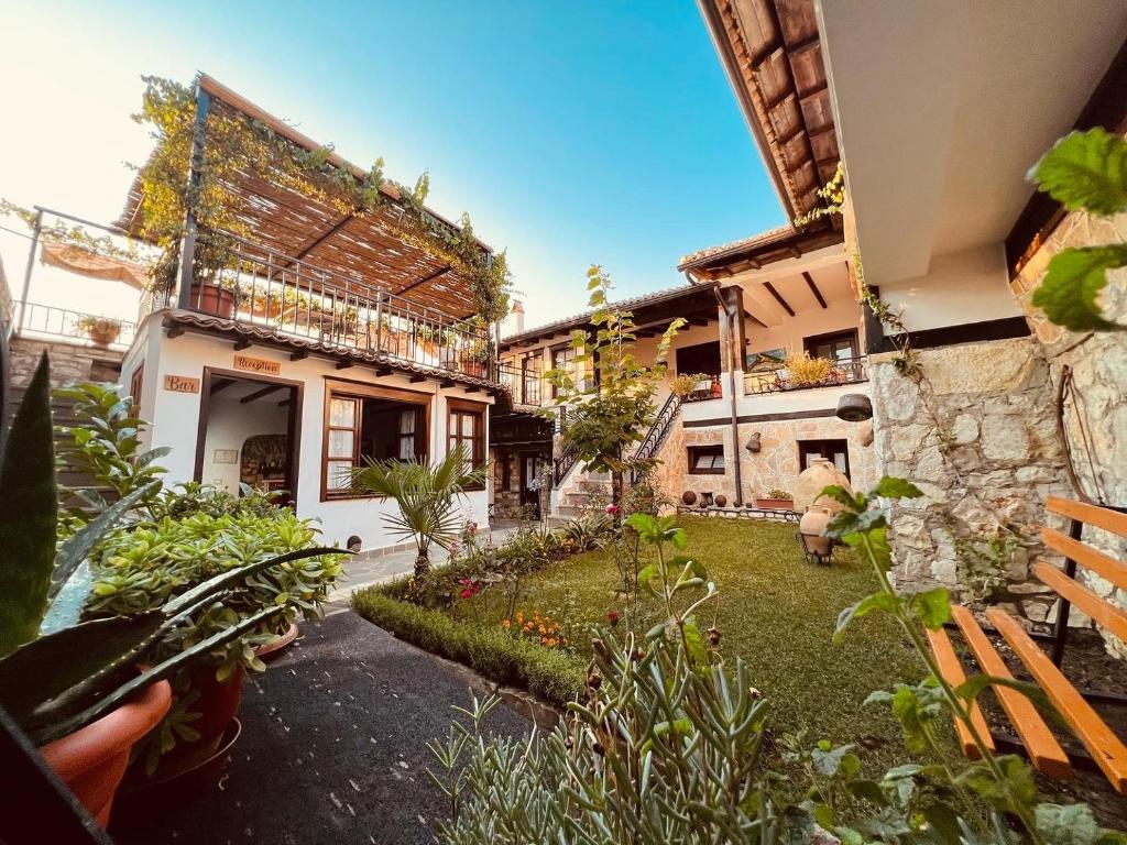 a courtyard of a building with a garden at KRIS Guesthouse in Berat