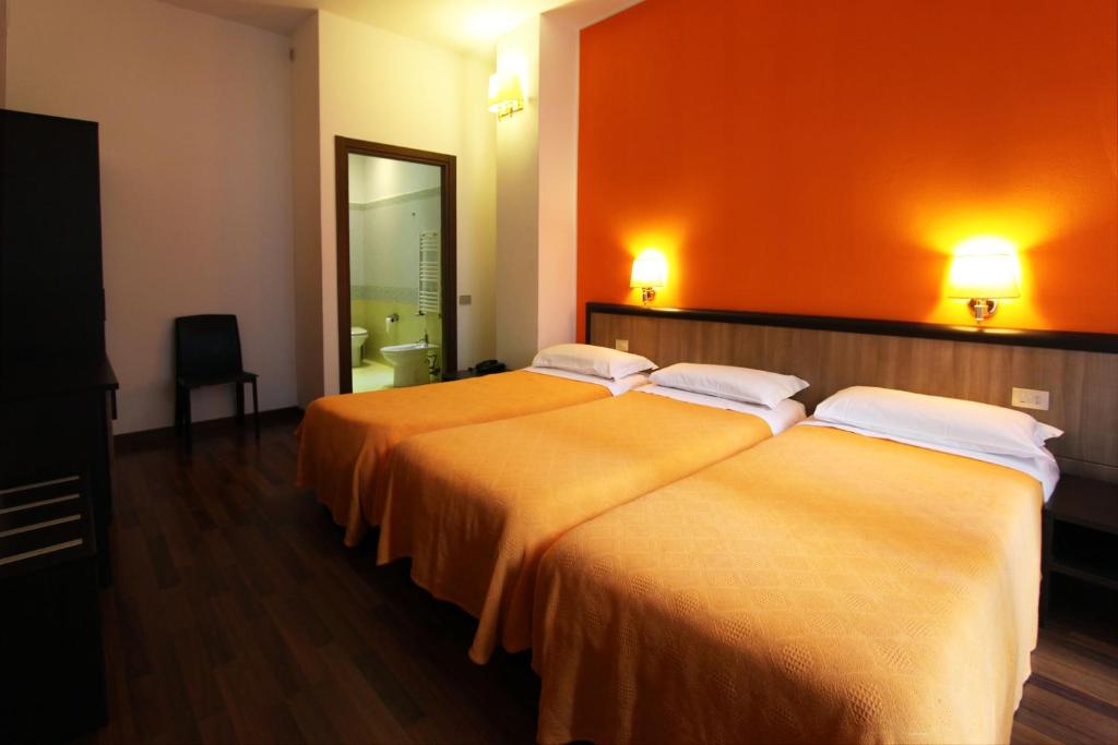 Postel nebo postele na pokoji v ubytování Lux Hotel Durante