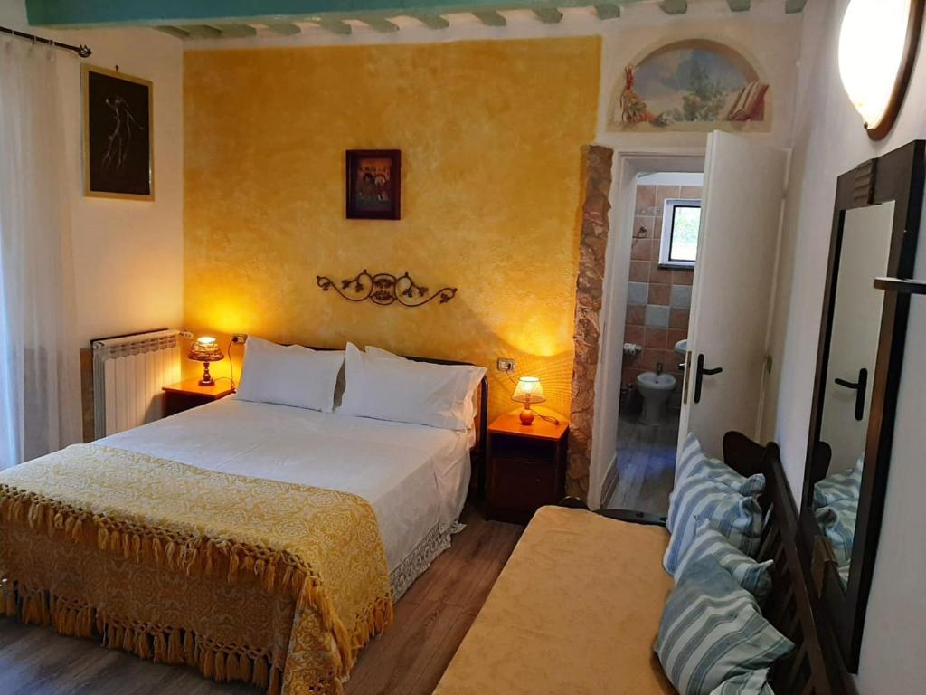 a bedroom with a bed in a room with yellow walls at B&B Natalia in Gualdo Tadino