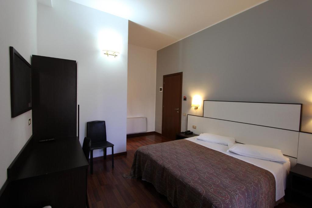 Postel nebo postele na pokoji v ubytování Lux Hotel Durante