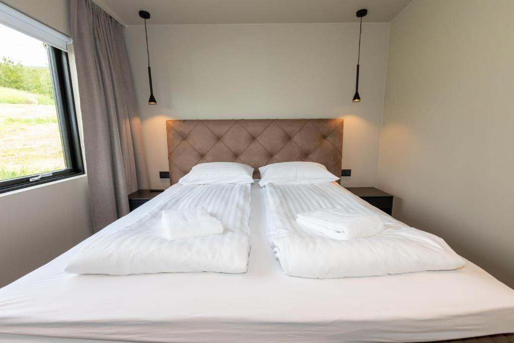 Rúm í herbergi á Hotel North