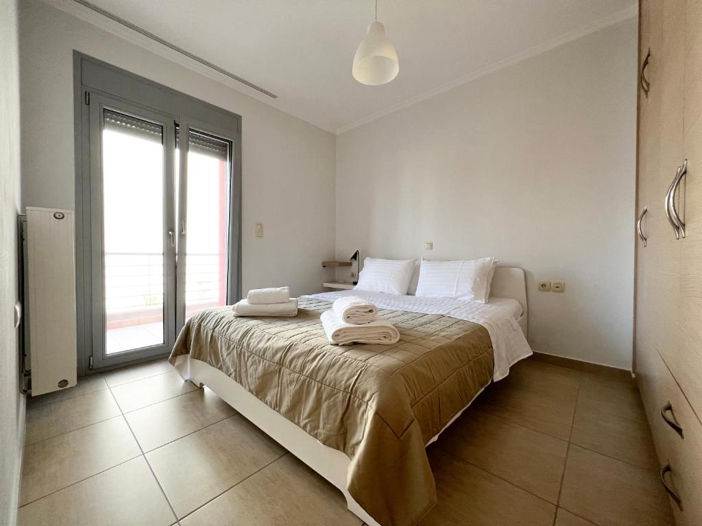a bedroom with a large bed with towels on it at Melcon Luxury House in Igoumenitsa