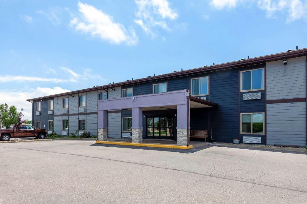 an empty parking lot in front of a building at Clarion Pointe Tomah in Tomah